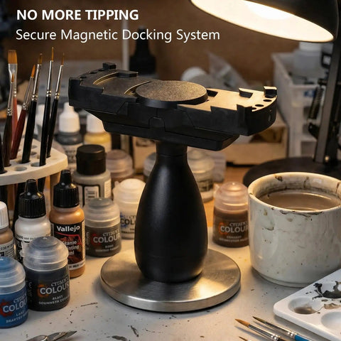 Large Magnetic Base Miniature Painting Handle With Stable Clamp For 50mm To 140mm Bases, shown on a cluttered workbench.