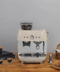 Top Shelf Semi Automatic Espresso Machine With Built In Conical Burr Grinder Dual Thermoblock Heating Precision Controls And Authentic 1950s Retro Vibe In Smooth Cream Finish on wooden table with coffee.