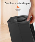 Person using manual dial control on Compact Desktop Personal Tower Heater With Two Heat Settings, 12 Inch Tall Black Design