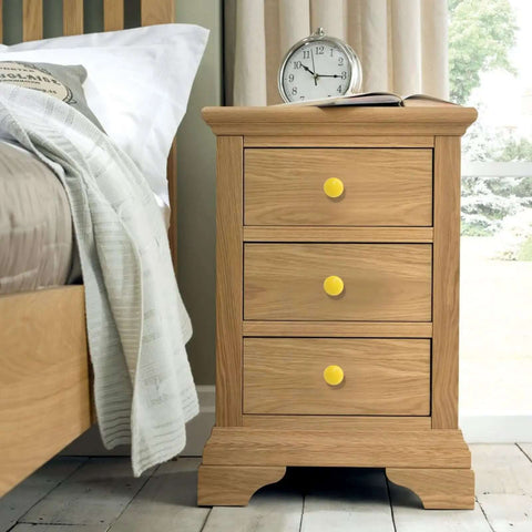 Top Shelf Yellow Ceramic Kitchen Cabinet Knobs, Super Solid 32 mm Round Pull Handles on a bedside table with three drawers.