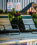 Two Pack Pool Signs 12x8 Inches Welcome To Our Pool And Funny Pool Rules Sign Set Durable 0.040 Aluminum Easy To Mount Great For Home Backyard Or Community Pools PSP2401 installed on fence near poolside chairs