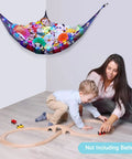 Cozy Plush Toy Hammock With LED Light, kids playing under black net storage with stuffed animals in girls' playroom corner