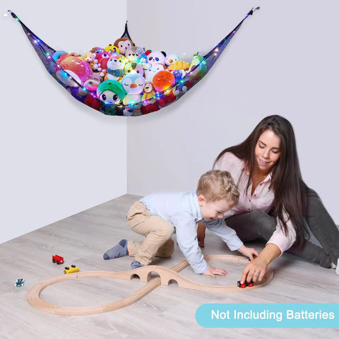 Cozy Plush Toy Hammock With LED Light, kids playing under black net storage with stuffed animals in girls' playroom corner