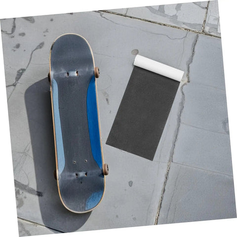 Rolled Premium Grip Tape Sheets For Skateboards And Electric Scooters Waterproof Non Slip Deck Cover next to skateboard on pavement