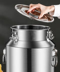 Heavy Duty 304 Stainless Steel Milk Can And Beverage Dispenser Built Tough With Airtight Seal For Bulk Grains Coffee And Liquids That Keeps The Goods Fresh No Stress Guaranteed, lid being lifted.