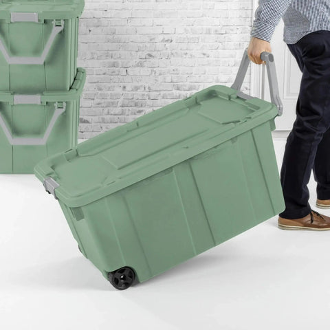 Person pulling 40 Gallon Wheeled Tough Plastic Storage Tote With Latch Lid Heavy Duty Green Industrial Bin For Tools Gear Camping