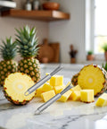 Two Pack Stainless Steel Pineapple Eye Peeler And Remover Tool, V Shape Eye Cutter displayed on kitchen counter with pineapples