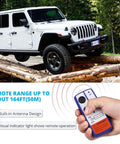 Jeep with 12V 500A Winch Solenoid Relay Contactor Kit and wireless remote, showing remote operation and built-in antenna design.