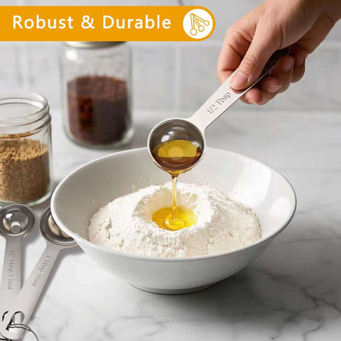 Pouring oil into flour using Six Piece Stainless Steel Measuring Spoons Set For Cooking And Baking Includes One Eighth Teaspoon One Quarter Teaspoon One Half Teaspoon One Teaspoon One Half Tablespoon One Tablespoon Coffee Scoop Rust Resistant Food Grade Kitchen Gadgets