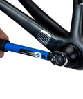12-Notch Bottom Bracket Tool For Praxis M30, Three Eighths Inch Drive Ratchet Compatible being used on a bicycle frame.