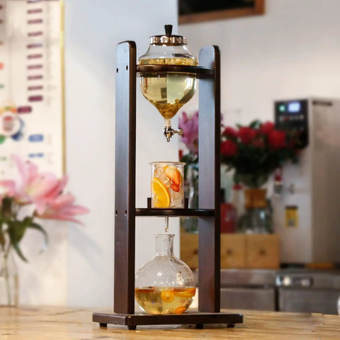 Top Shelf Cold Brew Coffee Maker With Adjustable Flow Valve And Thick Borosilicate Glass crafts eight cups on a wooden stand.