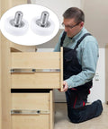 Six Piece Set Of 19mm White Plastic Drawer Rollers Featuring Slick Cabinet Pulleys For Smooth Operator Furniture Gliding No Sweat Replacement Wheels With Heavy Duty Mounting Nuts being installed in a cabinet.