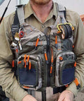 Man wearing lightweight mesh fishing vest for men and women with 17 pockets, breathable back panel, army green, fly fishing gear visible