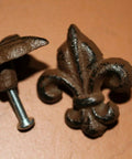 Close-up of Old School Vintage Fleur De Lis Cabinet Knobs Set, cast iron Victorian style hardware, showing screw detail and finish.