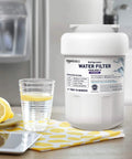 Replacement GE MWF Water Filter Cartridge For GE And Kenmore Refrigerators on a kitchen counter with glass of lemon water