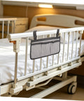 Bed Rail Organizer Bag With Adjustable Strap And Four Storage Pockets Gray Bedside Hanging Caddy attached to hospital bed rail
