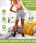 Woman standing in living room wearing Open Heel Ankle Support Sleeve With Light Breathable Knit Fabric, black, Size M.
