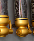 Killer Wall Mounted Coffee Bean Dispenser With Durable Aluminum And Clear Acrylic Canister Totally Airtight 5KG Storage Jar For Home Baristas Or Cafe Stash In Glossy Gold Two Pack showcasing gold dispensers with various coffee beans.