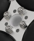 Close-up of compact double aluminum omni wheel hub with four bolts and white center insert on metal plate.