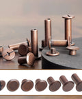 Heavy Duty Chicago Screws And Leather Rivets 110 Set Kit With Install Tools showing antique copper rivets on a wooden surface.