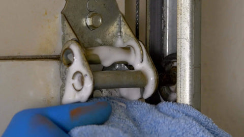 Silicone Garage Door Lubricant Spray for smoother quieter operation on tracks rollers and hinges will not attract dust or dirt tack-free formula applied to garage door hinge.