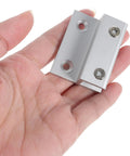 Hand holding heavy duty aluminum alloy glass shelf brackets set with beefy carrying capacity and easy install, two hole floating shelf clips