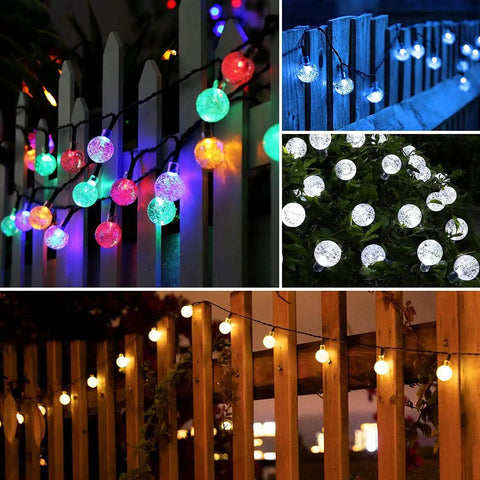 Solar Powered String Lights With 200 LEDs, 72 ft Long, 8 Modes, Waterproof Crystal Globe Balls illuminating a fence