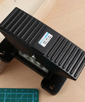 Five Way Three Position Center Closed Pneumatic Foot Pedal Valve With Leak Proof Zinc Alloy Body on wooden surface