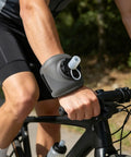 Cyclist wearing Hydration On The Wrist On The Go 200ml Silicone Leakproof Wearable Bottle with strap for outdoor training