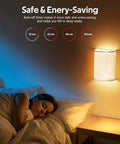 Bedroom with girl sleeping under warm glow of Set of Two Battery Rechargeable Wall Sconces With Remote Control, fabric shade visible.