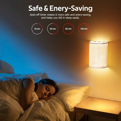 Bedroom with girl sleeping under warm glow of Set of Two Battery Rechargeable Wall Sconces With Remote Control, fabric shade visible.