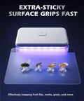 No Nonsense Plug In Fruit Fly Trap For Indoor Spaces Featuring Dual Wavelength Bulbs Paired With Eleven Sticky Refill Pads showing trapped bugs.