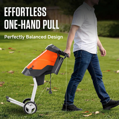 Person pulling Electric Wood Chipper Shredder With 15 Amp Beast Power For Branches Up To 1.8 Inches on grass using handle