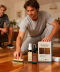 Man using Easy Wood Repair Kit for Furniture Scratches and Nicks Odorless Plant Based Formula on wooden floor indoors.