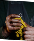 Built Tough Manganese Steel Wedge Locking Washers Heavy Duty Anti Loosening Hardware For Machinery And Construction Vibration Resistant Bolt Stabilizers That Lock Down With Zero Wiggle Room in dirty hands holding yellow cloth.