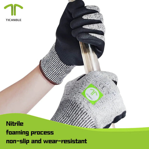 Three Pair Level Five Cut Resistant Gloves With Nitrile Coated Grip holding a metal pole, showcasing non-slip and wear-resistant features.