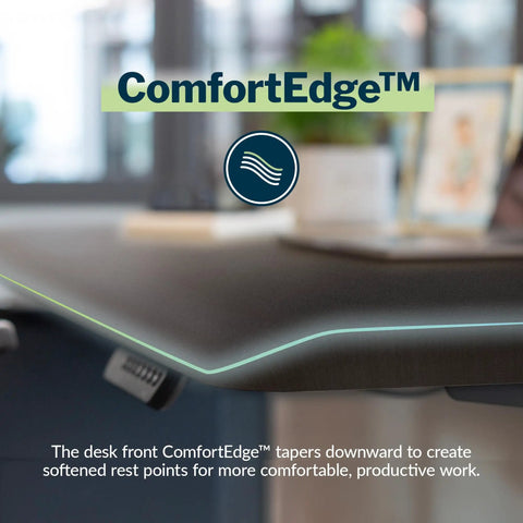Close-up of Vari ComfortEdge Electric Standing Desk 60X30 Black with tapered front edge for ergonomic wrist relief.