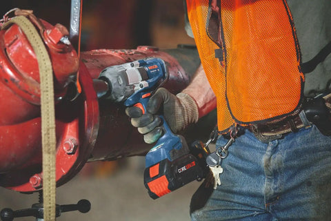 Heavy Duty 18 Volt Cordless Impact Wrench With Half Inch Drive Friction Ring and Beast Mode Torque in use on large pipe fittings.
