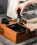Heavy Duty Solid Walnut Espresso Tamper Station with Integrated Knock Box in use, showcasing 58 Mm portafilter setup.