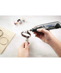 Ultra Compact Four Volt Cordless Rotary Tool Featuring Variable Speed And No Sweat Accessory Swaps For Grab And Go Crafting, used on metal ring.