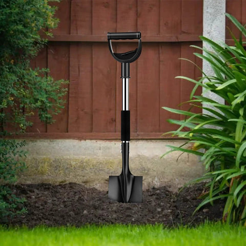 Heavy Duty 31 Inch Shovel With D Handle For Camping And Digging, Tough Steel Spade For Edging And Quick Work, Lightweight Yet Strong Metal Tool In Black standing upright in a garden setting, showing black spade and handle.