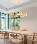 39 Inch Boho Rattan Chandelier With Six Warm Bulbs Hits Different On Your Kitchen Island Dining Table Or Living Room Ceiling Using Real Natural Weave And Seamless Brass Rods Built Big Time Safe Through UL Certification above a dining table with wooden chairs and decorative vases.
