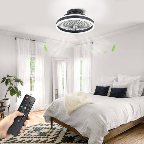 Person using remote for Invisible Ceiling Fan With Lights, 16-Inch Flush Mount with LED light in modern bedroom.