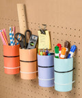 Colorful desk organizers holding stationery on a pegboard wall with Heavy Duty 12 Inch Black Cable Ties Pack Of 100 For Outdoor Use With 60 Pound Tensile Strength Self Locking Fasteners That Stay Locked In Place Tough As Nails For Outdoor Ready Handling And Reliable Performance