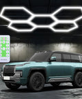 Hexagon Garage Lights 60W 24V Daylight White 6500K Plug And Play LED Kit With Remote Dimmer illuminating a garage with a car.