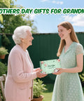 Two women exchanging All In One Garden Gift Set For Women Pink Edition With Hand Fork Trowel Gloves Apron And Tools Kit Gift Box Included Perfect Birthday Present For Mom Grandma Wife Garden Lovers outdoors.