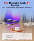 Matter Enabled Smart Smoke Detector Leveraging Local Thread Connectivity Works Smoothly With Apple Home And Alexa on desk with laptop.