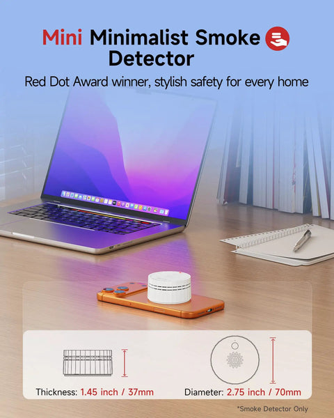 Matter Enabled Smart Smoke Detector Leveraging Local Thread Connectivity Works Smoothly With Apple Home And Alexa on desk with laptop.