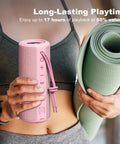 Person holding pink Outdoor Portable Bluetooth Boombox Speaker Waterproof, True 16W Power Sound, next to yoga mat.