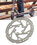 135mm Electric Scooter Brake Disc Replacement Stainless Steel Rotor Enhanced Heat Dissipation Smoother Braking Easy Install for Quick Maintenance and Reliable Ride shown with scooter